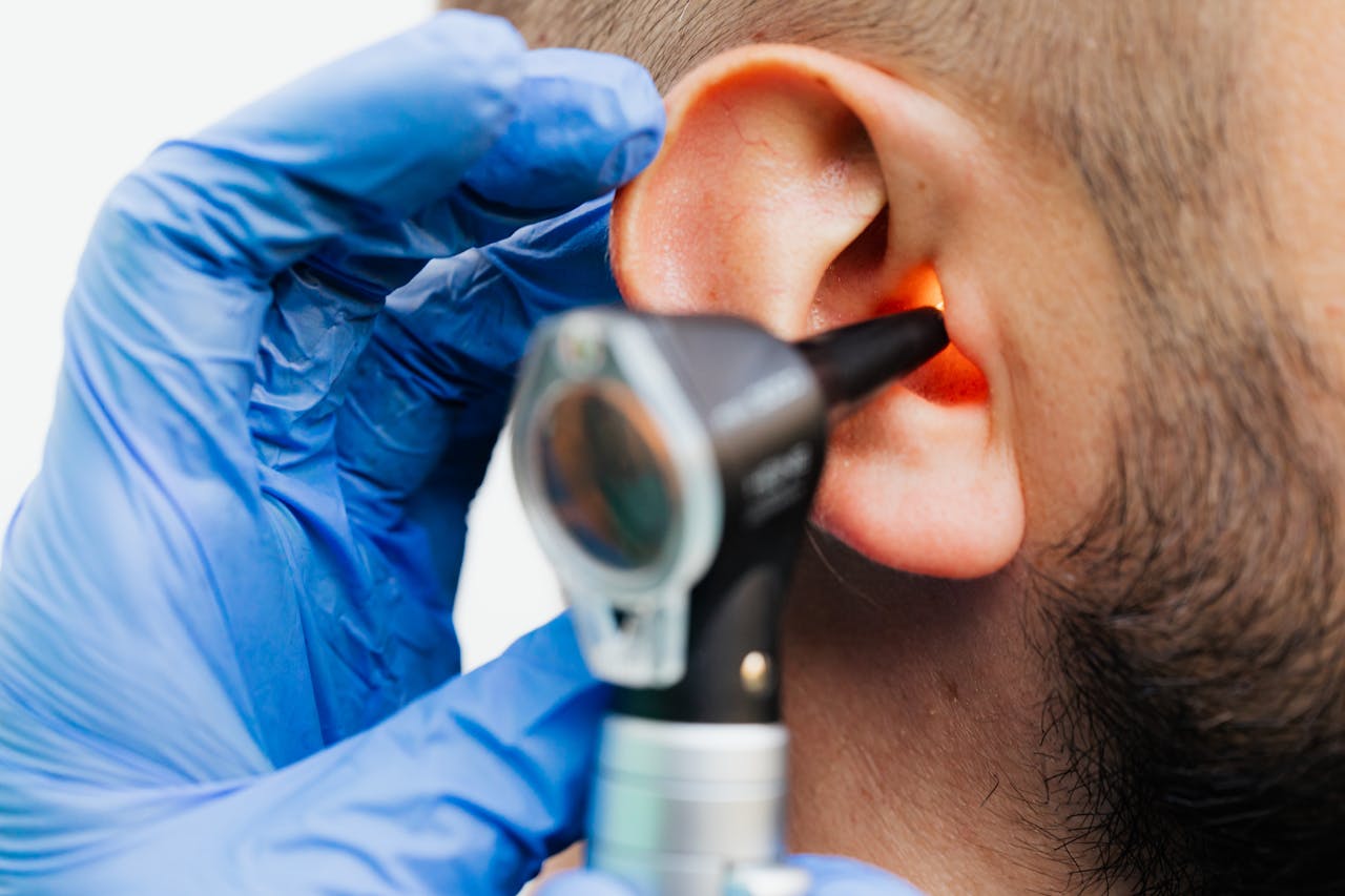 Mastering the First Impression: Your intriguing post title goes here Close-up of a doctor using an otoscope to examine a patient's ear in a clinical setting.